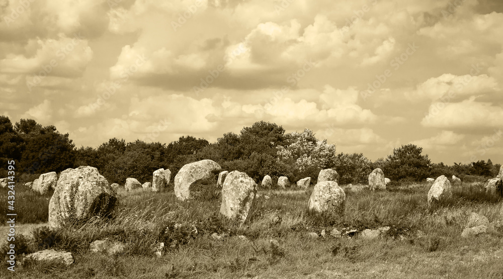 Menhirs - big megalithic monuments near Carnac. Brittany, France. Tourist attractions. Sepia historic photo