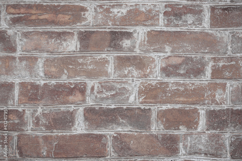 Brown brick wall with scratches  cracks  dust  crevices  roughness. Can be used as a poster or background for design.