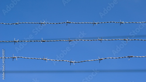 barbed wires against blue background