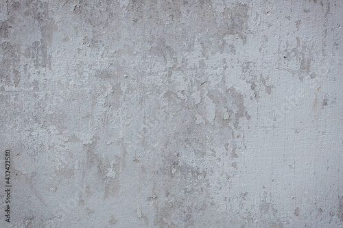 The texture of the old stucco wall with scratches, cracks, dust, crevices, roughness. Can be used as a poster or background for design.