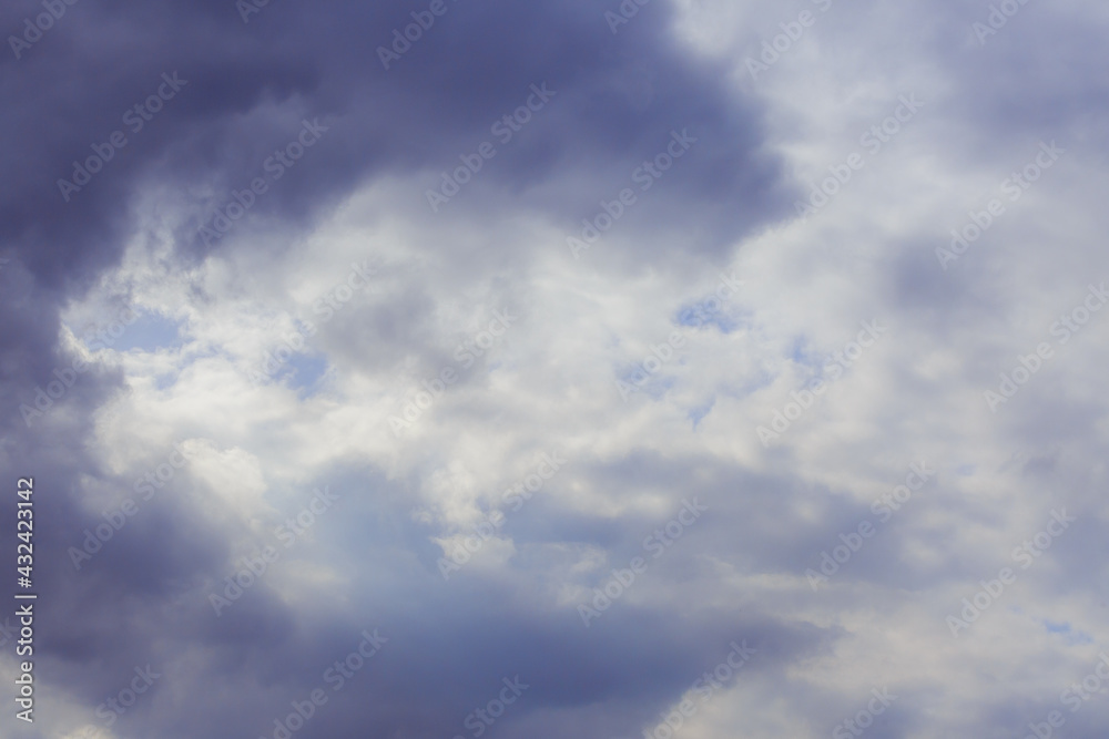 Cumulus clouds. Beautiful dark blue dramatic sky. Free space for lettering.