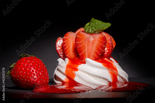 Individual Strawberry Pavlova with a strawberry coulis