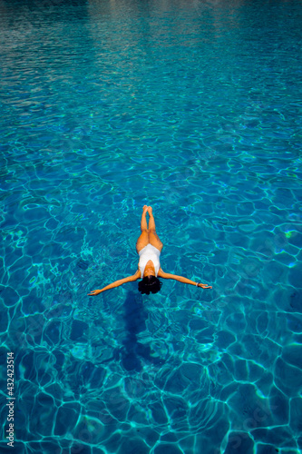 young woman floating in crystal clear sea water © Gianni Orsatti