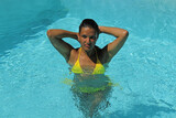 girl in bikini walking out of pool