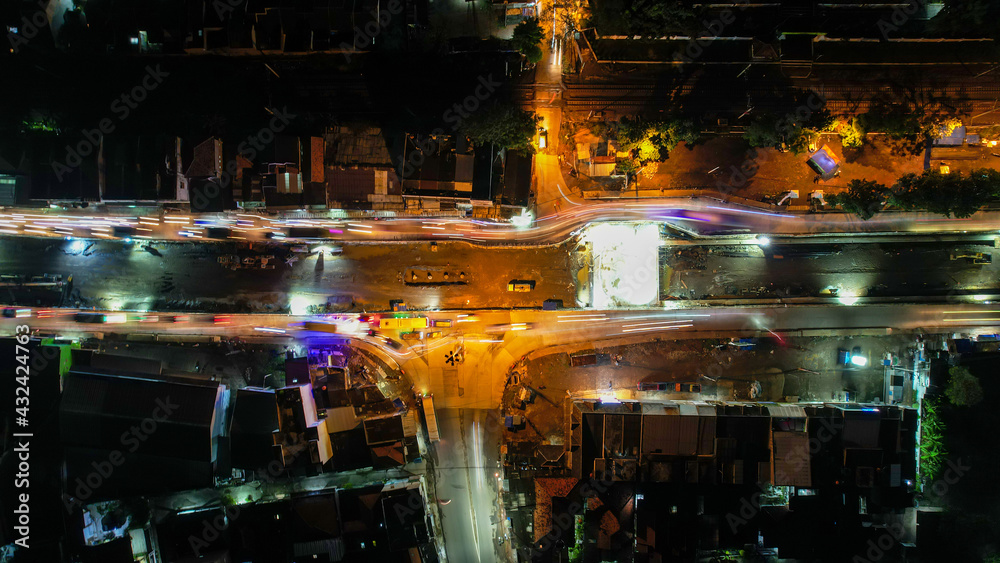 Traffic jam on the polluted streets of Bekasi at night. The traffic congestion is limited in few areas, selective focus on the road. Bekasi, Indonesia, May 8, 2021