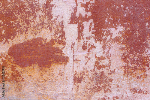 Texture of the dark orange stucco wall with scratches, cracks, dust, crevices, roughness. Can be used as a poster or background for design.