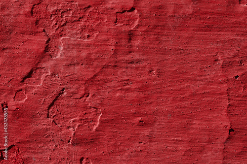 Texture of the red stucco wall with scratches, cracks, dust, crevices, roughness. Can be used as a poster or background for design.