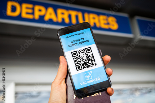 health Vaccine Passport for Coronavirus or Covid-19. Traveller Using Mobile Phone with Vaccination in Immune Status to Certificated International Traveling in Airport photo