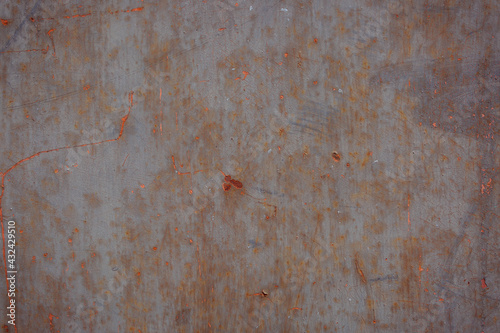Gray rough background with peeling paint and color streaks. Surface with scratches, chips and colored lines. Elements of corrosion and fading. © INTHEBLVCK