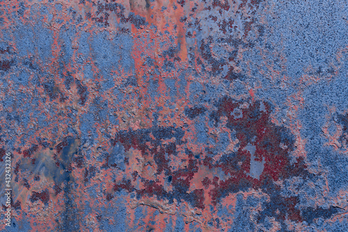 Dark orange-brown metal texture with a rough surface. Traces of corrosion and elements of paint streaks and fading in the sun.