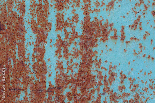 Blue metal texture with a rough surface. Traces of corrosion and elements of paint streaks and fading in the sun.