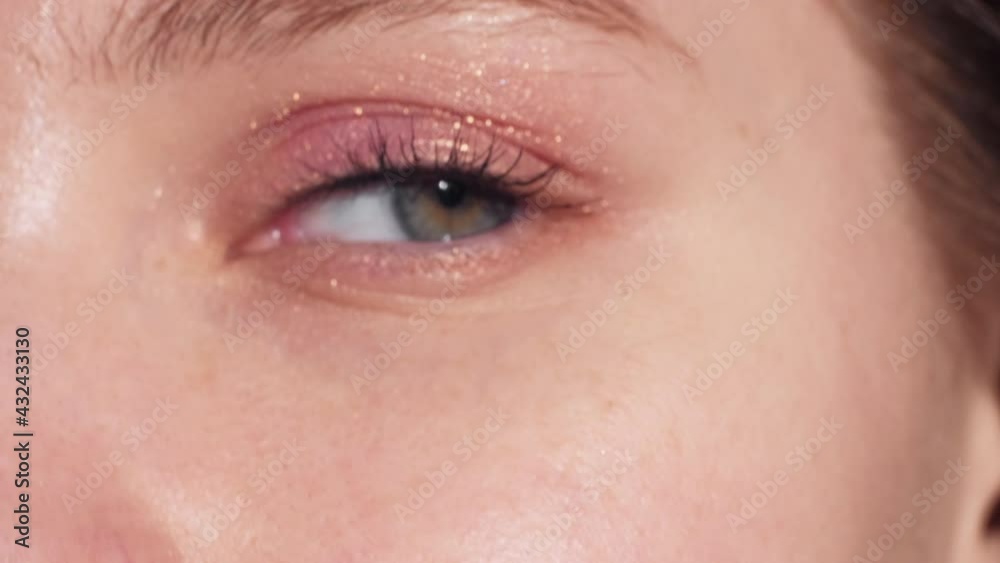 Natural beauty. Female cosmetic. Nude makeup. Perfect skin. Unrecognizable woman eye with pastel eyeshadow looking at camera selective blur.