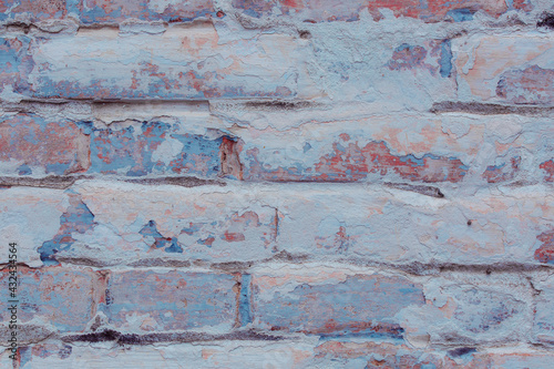 Texture of an old brick wall with shabby blue plaster. Natural damage to the paintwork. Natural aging concept. © INTHEBLVCK