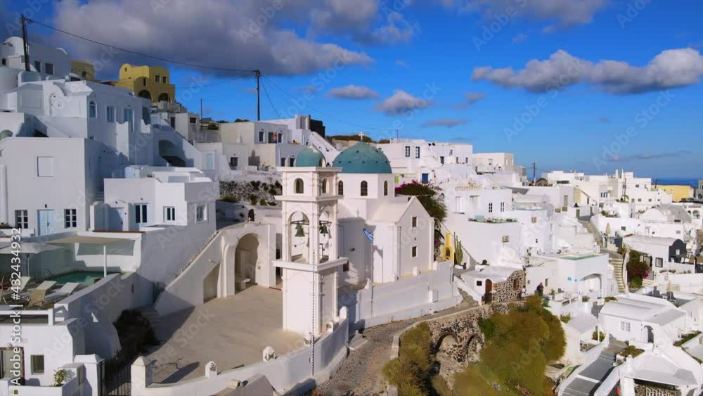 Aerial: Drone Panning Shot Of Famous Anastasi Orthodox Church In City Against Sky On Sunny Day - Santorini, Greece