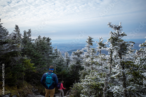 Two hikers navigate the Camel's Hump trail in Vermont after light snow