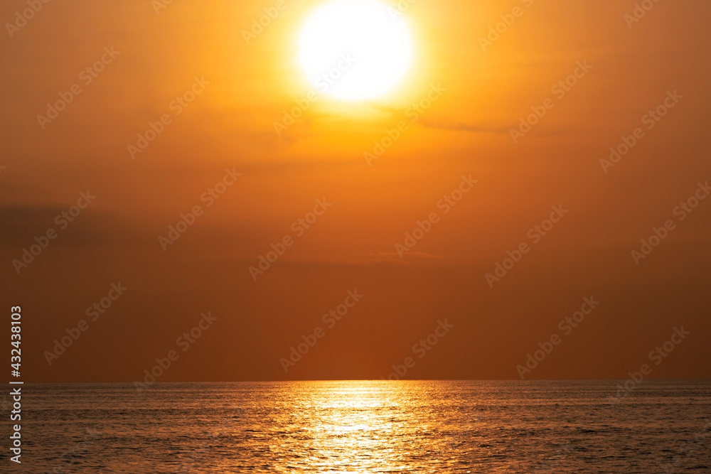 Amazing sun over the tropical sea in Summer paradise island as the sunset or sunrise over the waves sea surface