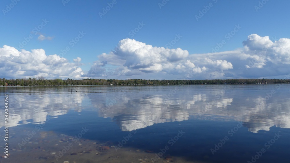 Northern Michigan lake with clouds reflected.