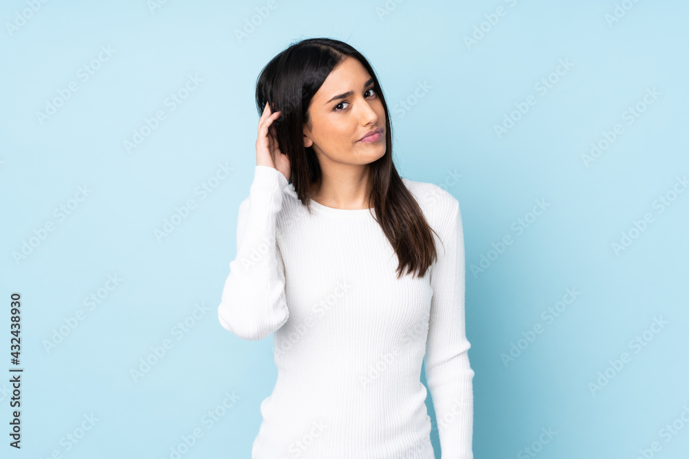 Young caucasian woman isolated on blue background having doubts Young caucasian woman isolated on blue background having doubts