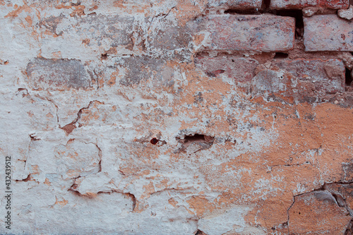 Old brick wall with cracks, cement and blue plaster Can be used as a poster or background for design. 