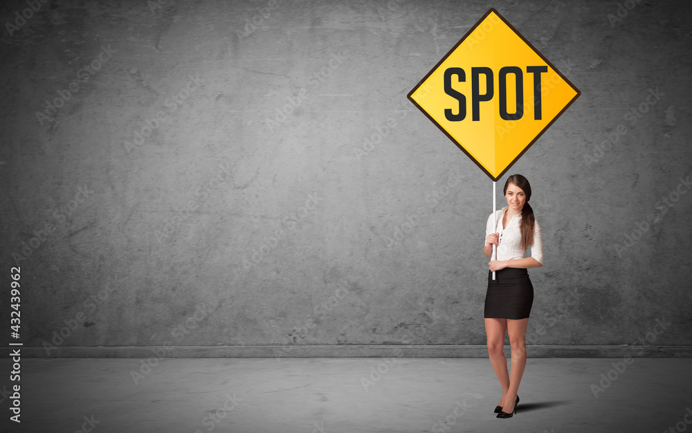 Obraz premium Young business person holding road sign