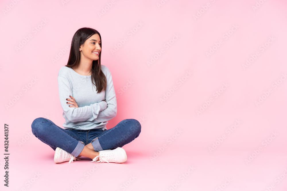 Young caucasian woman isolated on pink background in lateral position Young caucasian woman isolated on pink background in lateral position