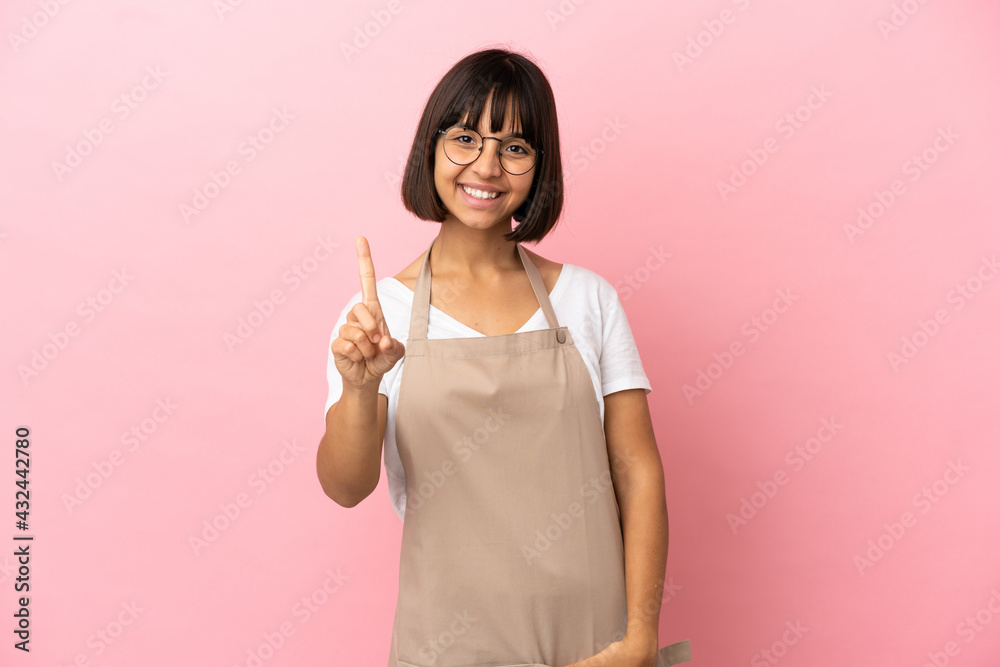 Restaurant waiter over isolated pink background showing and lifting a finger Restaurant waiter over isolated pink background showing and lifting a finger