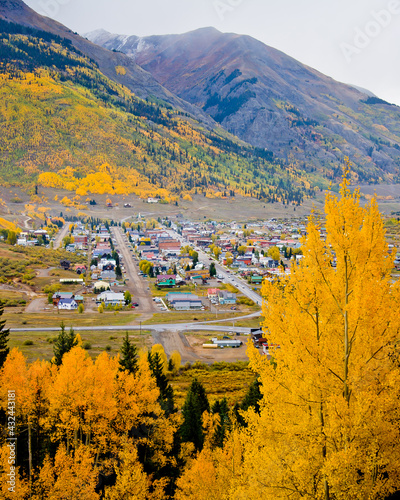 Silverton Colorado surrounded by gold and orange autumn leafed aspen trees on a foggy fall day in San Juan County, Colorado photo