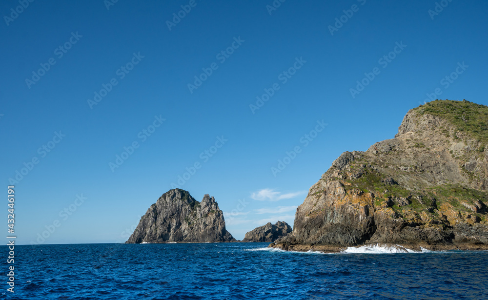 Motukokako Islands on a Bright Sunny Day at the Hole in the Rock Bay of Islands New Zealand