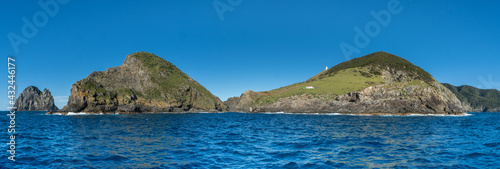 Panorama of Cape Brett Lighthouse with the Hole in the Rock in the Distance, Bay of Islands New Zealand photo