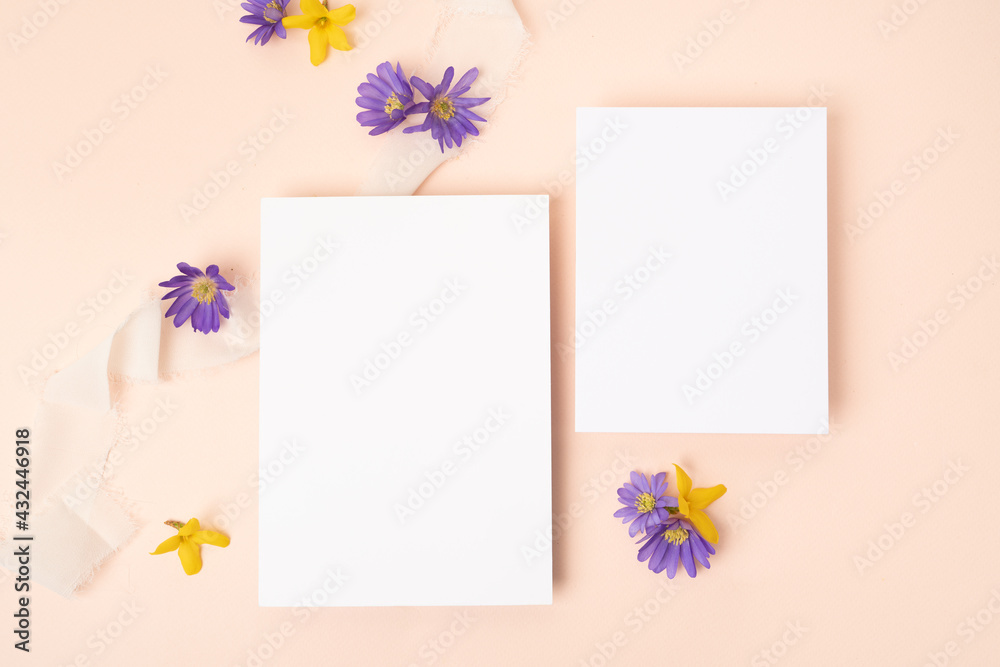 Fresh flower stationery flat lay with two blank cards on blush background Fresh flower stationery flat lay with two blank cards on blush background