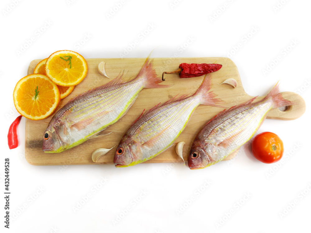 Fresh Pink Perch fish with ingredients like lemon,curry leaves,chilli,selective focus.white background. Fresh Pink Perch fish with ingredients like lemon,curry leaves,chilli,selective focus.white background.