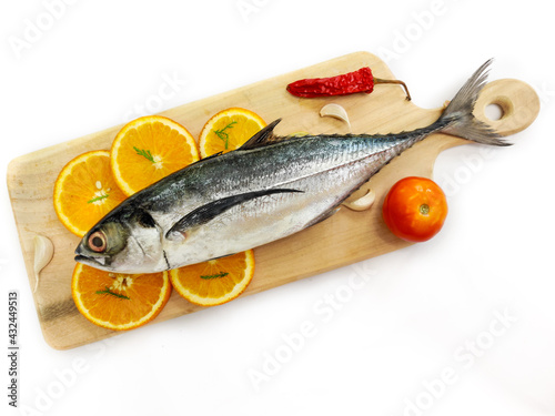 Close up view of fresh Finletted Mackerel Fish or Torpedo Scad Fish decorated with herbs.White background,Selective focus. photo