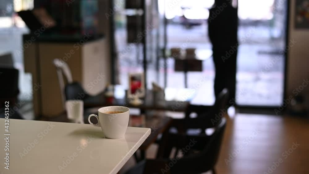 White coffee mug on the table inside the cafe