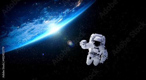 Fototapeta Naklejka Na Ścianę i Meble -  Astronaut spaceman do spacewalk while working for space station in outer space . Astronaut wear full spacesuit for space operation . Elements of this image furnished by NASA space astronaut photos.