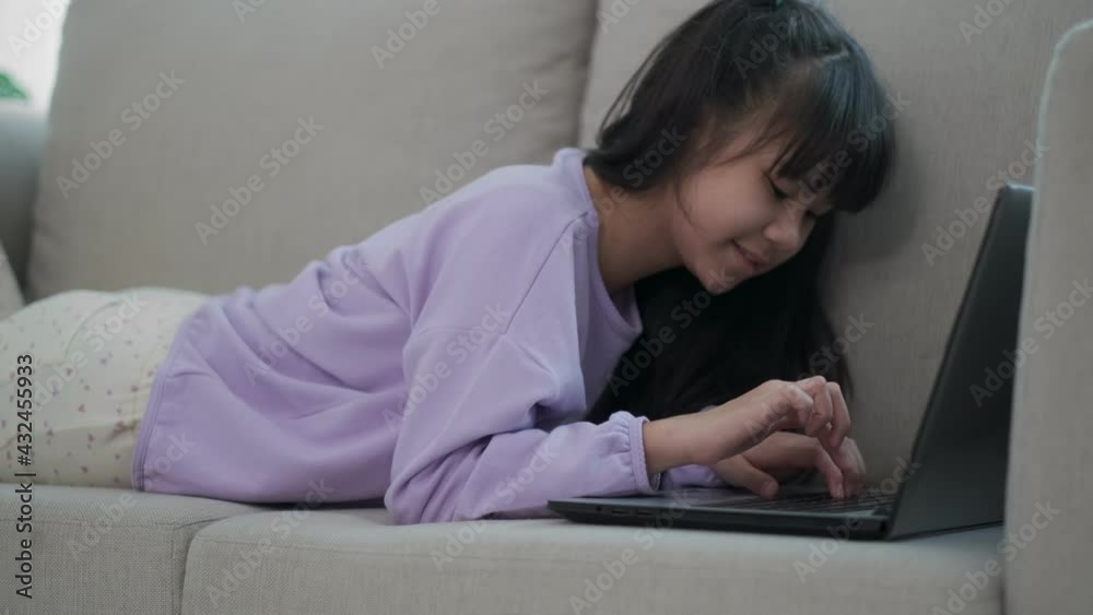 Teenager girl busy to learning looking a screen laptop And type the keyboard during a social distance after coronavirus crisis. online learning at home and new normal concept. Teenager girl busy to learning looking a screen laptop And type the keyboard during a social distance after coronavirus crisis. online learning at home and new normal concept.