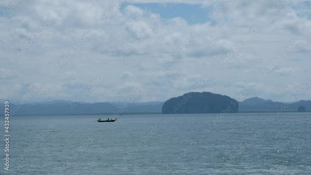 A long tail boat sailing in the sea A long tail boat sailing in the sea
