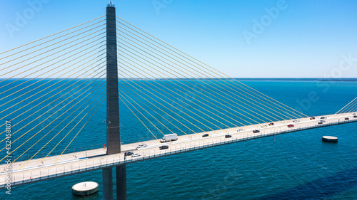 Fototapeta Naklejka Na Ścianę i Meble -  Sunshine Skyway Bridge in Tampa Bay Florida. Large Suspension Bridge that ships pass underneath. Florida gulf coast fishing pier.