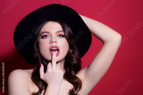 Sexy woman licking middle finger. Fuck you concept. Offensive gesture. Middle finger girl.