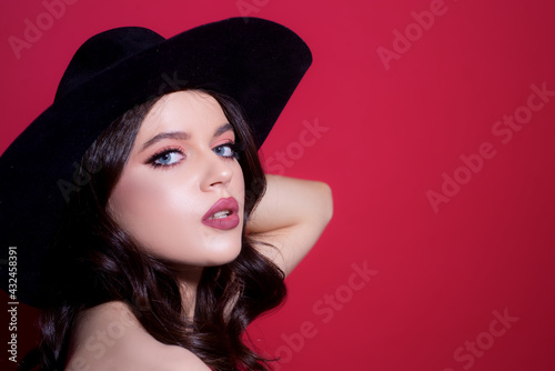Fashion style portrait of trendy girl in black hat. Elegant lady. Sensual woman vogue.