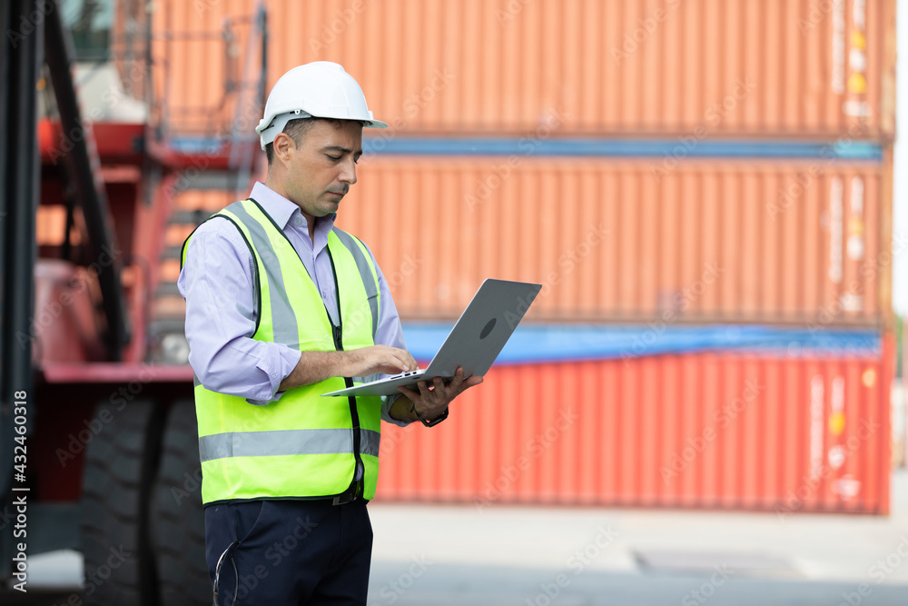 factory workers or engineers using laptop computer for work in containers warehouse storage factory workers or engineers using laptop computer for work in containers warehouse storage