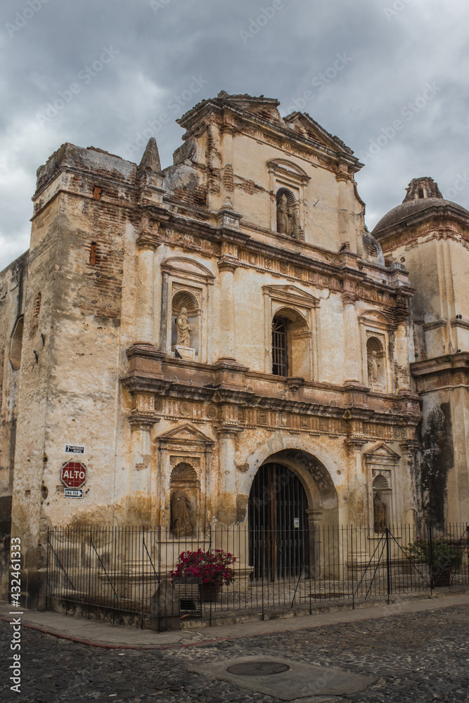 convent and church with a classical architecture style in a colonial old town in the middle of a dark and cloudy afternoon
