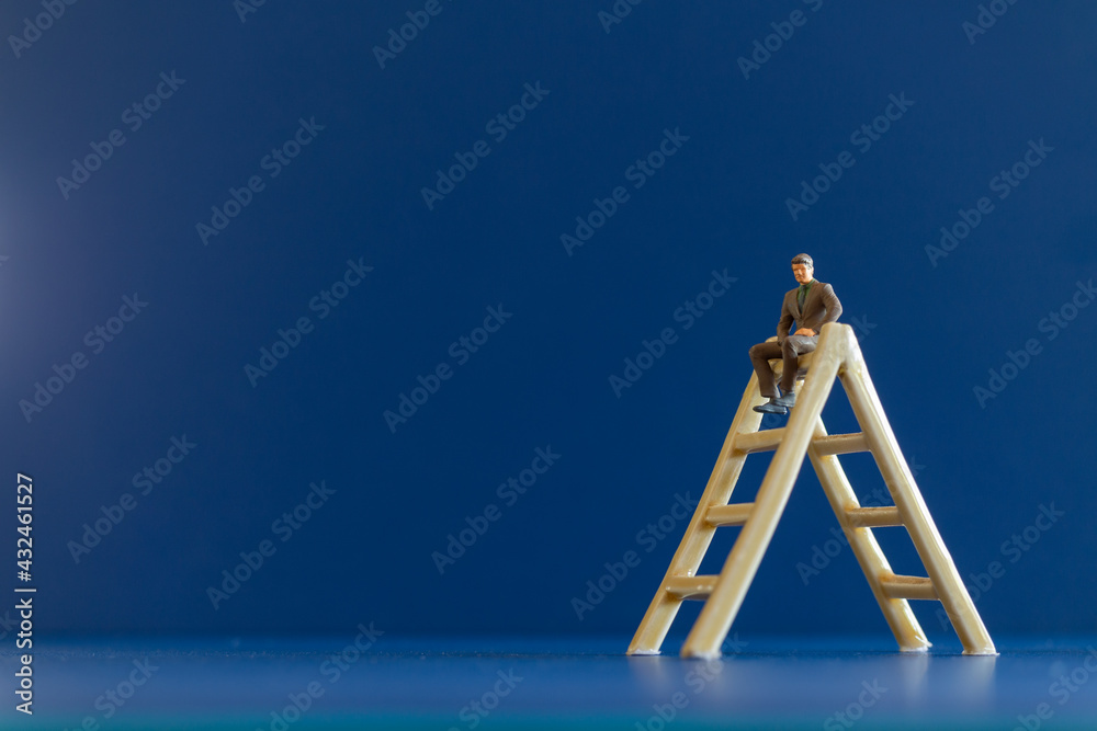 Miniature people businessman sitting on stair and space for text . Business Growth concept Miniature people businessman sitting on stair and space for text . Business Growth concept
