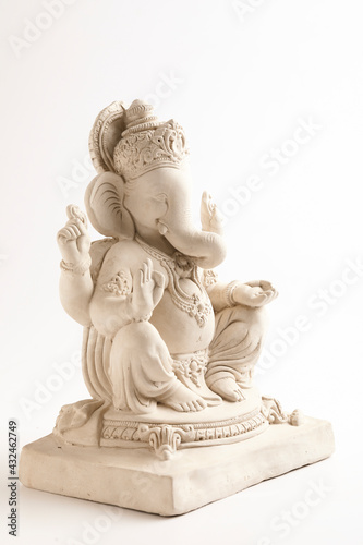 Statue of Lord Ganesha Made from plaster of Paris without color on white background. © Niks Ads