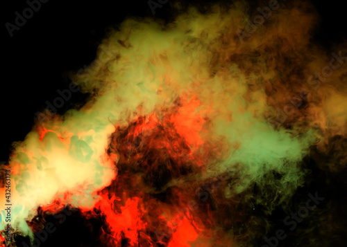 Red and green smoke on a black background.