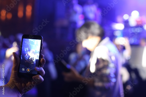 phone in the night city. people dancing in nightclub