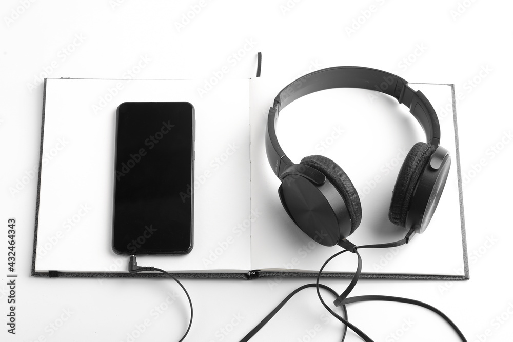 work from home concept. smartphone, diary and earphone on white background work from home concept. smartphone, diary and earphone on white background
