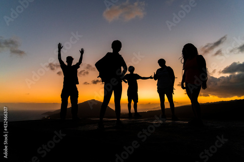 People stand at the top of a hike