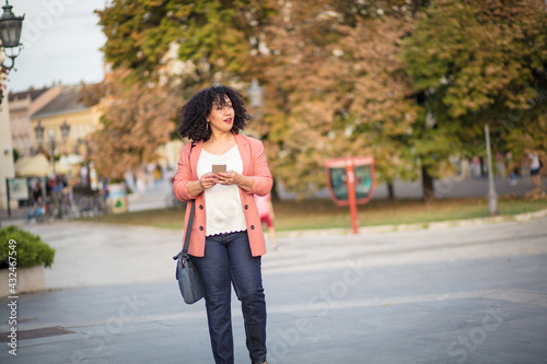 Business woman walking trough city.