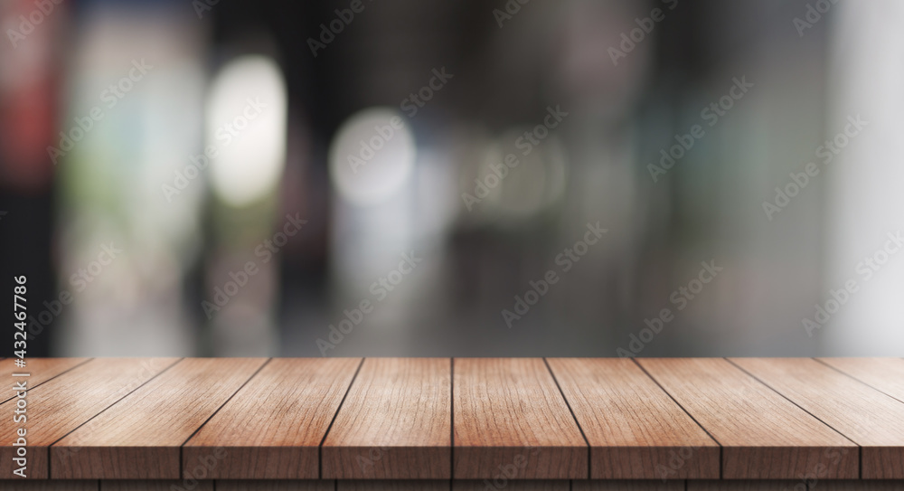 Empty wooden table top on blur restaurant background.