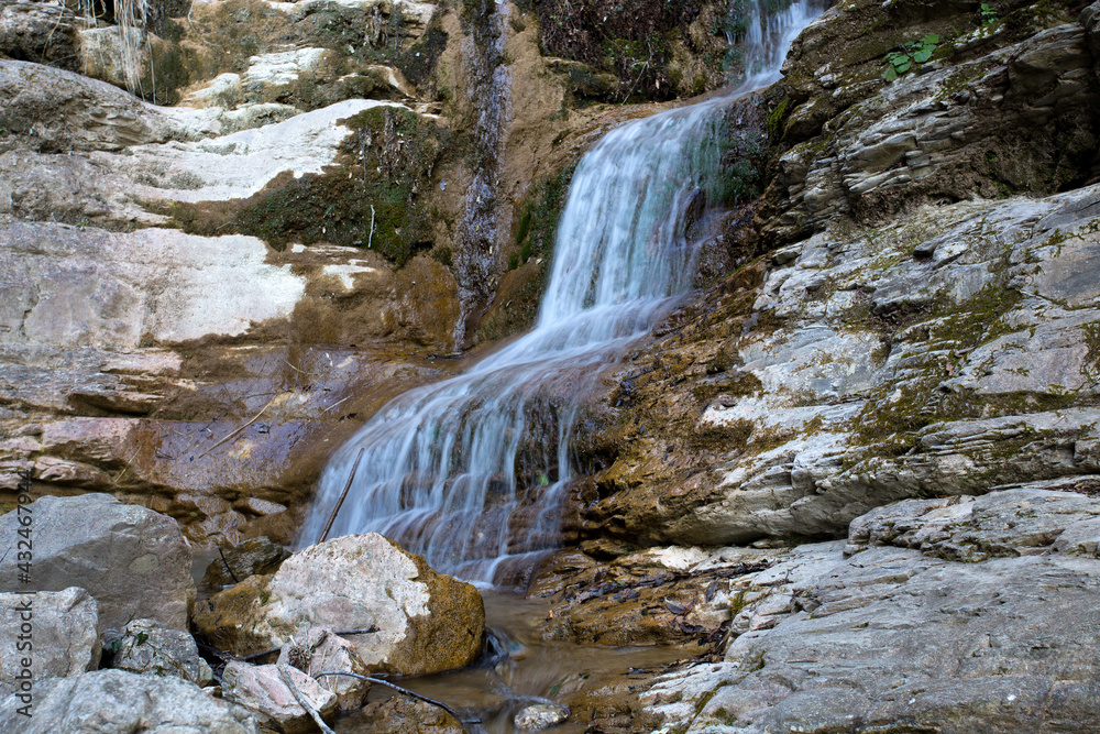 Fototapeta premium Isolated waterfall in the forest, Italy, Europe